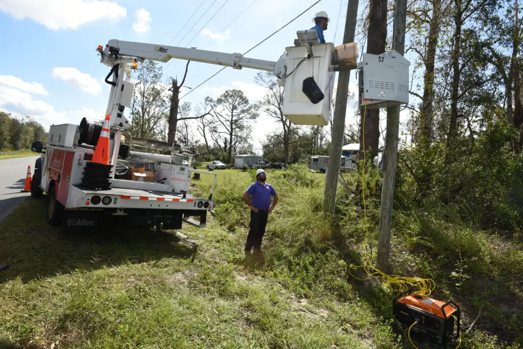 Xfinity technicians in a bucket truck work to restore connectivity after a severe storm.