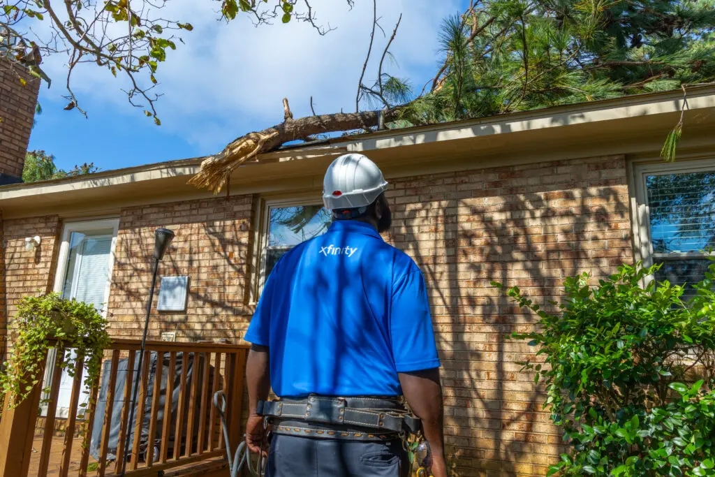 Xfinity tech looking at damage after a storm.