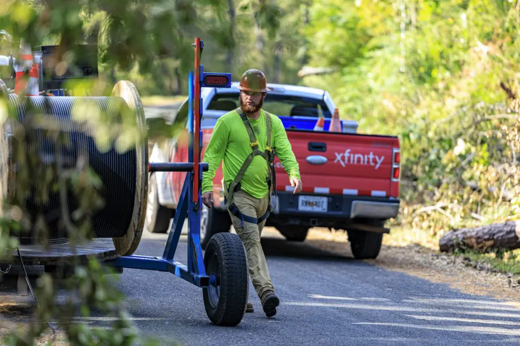 Xfinity tech replacing fiber network after storm.