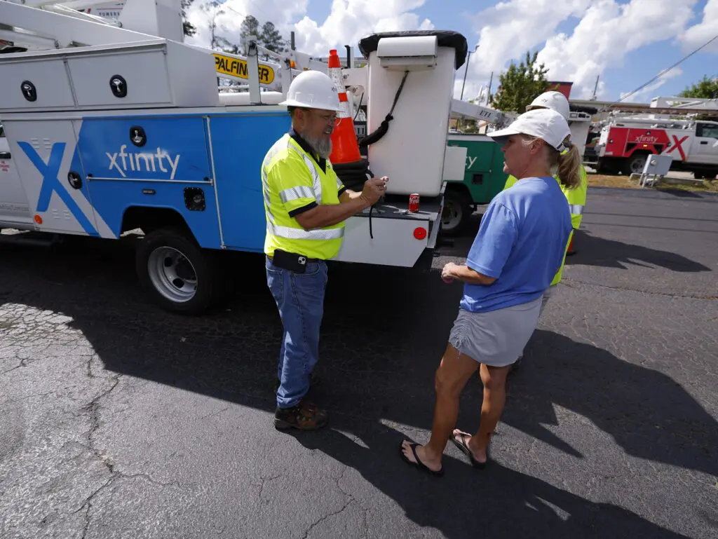 Xfinity technicians and customer discuss restoration efforts after major storm.