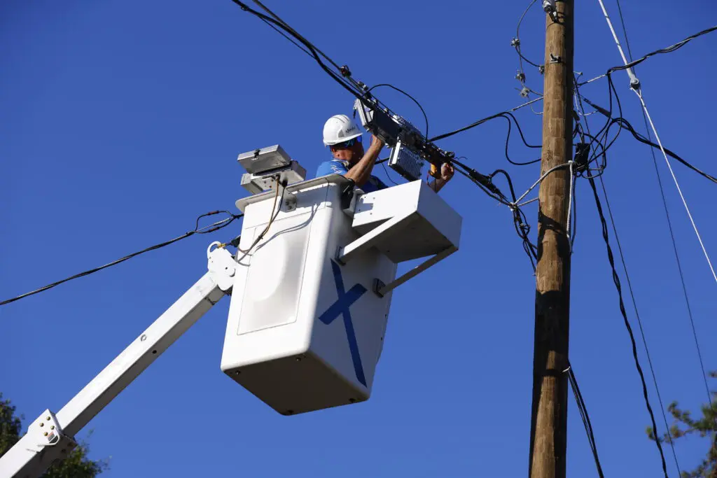 Xfinity technician works to restore connectivity after a major storm.