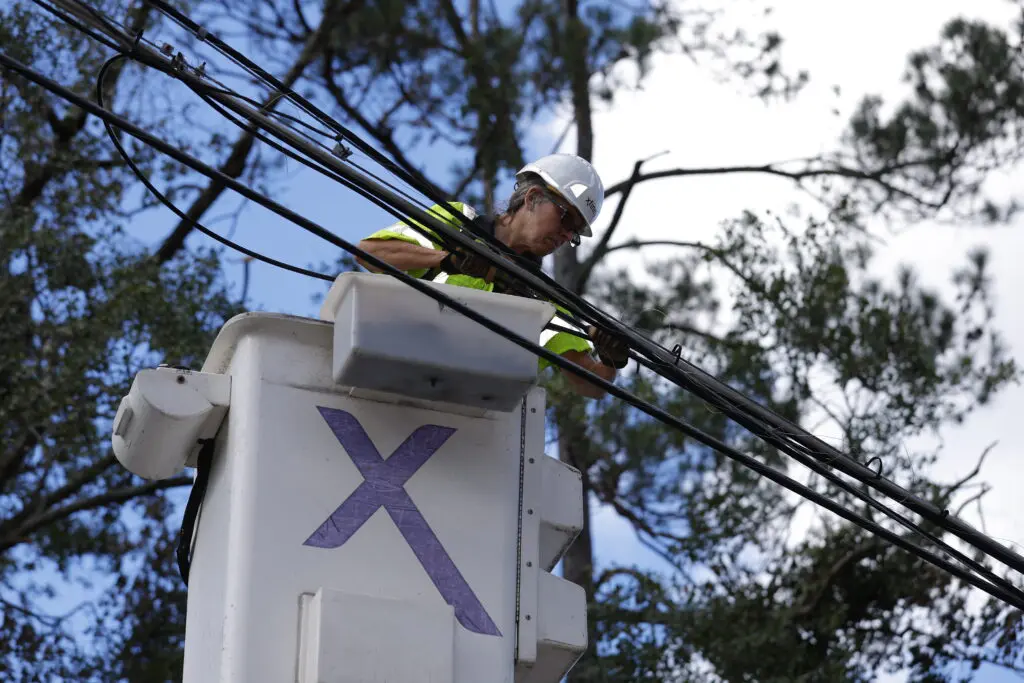 Xfinity technician works to restore connectivity after a major storm.
