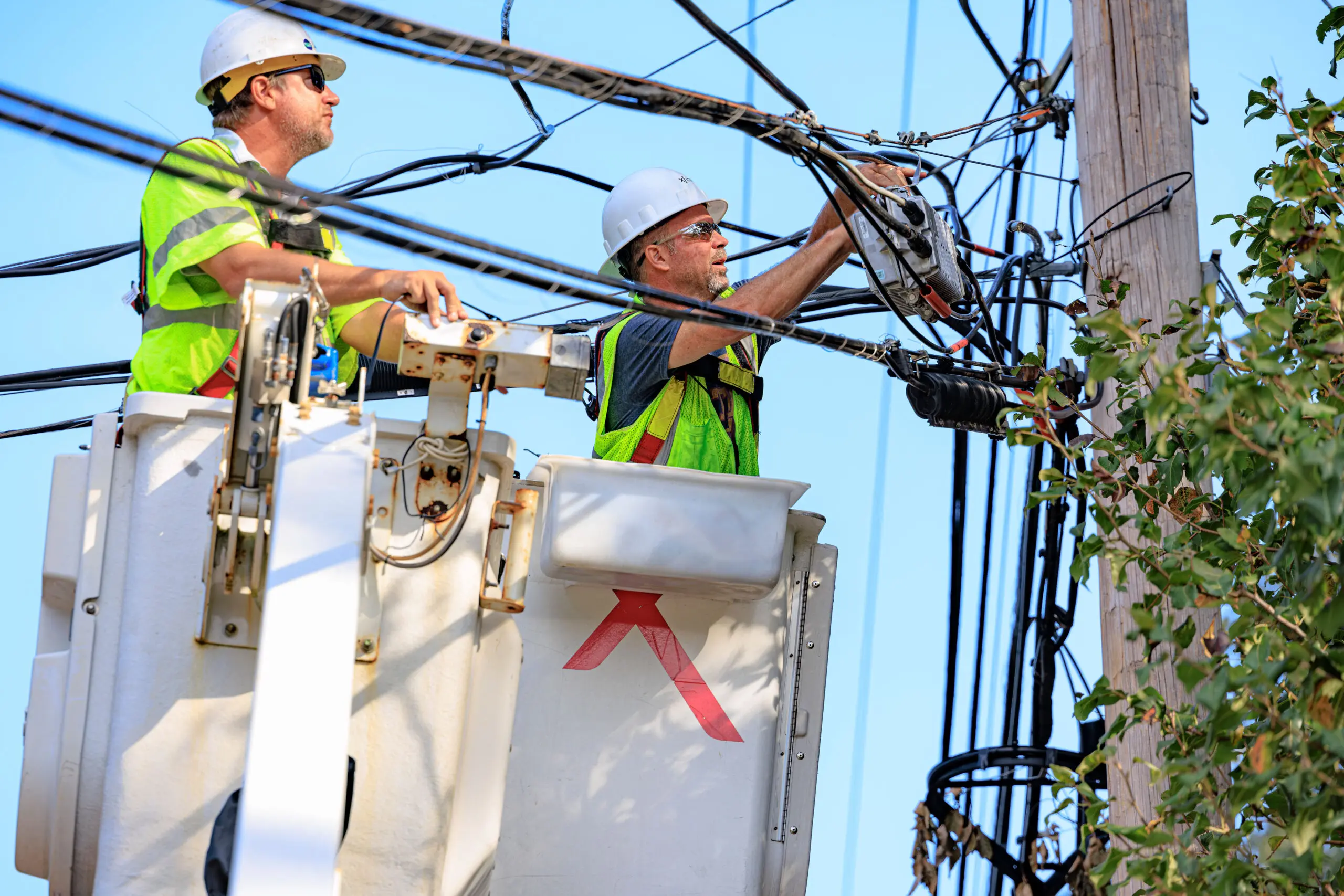 Comcast tech works to repair lines and equipment post storm to restore connectivity to customers.