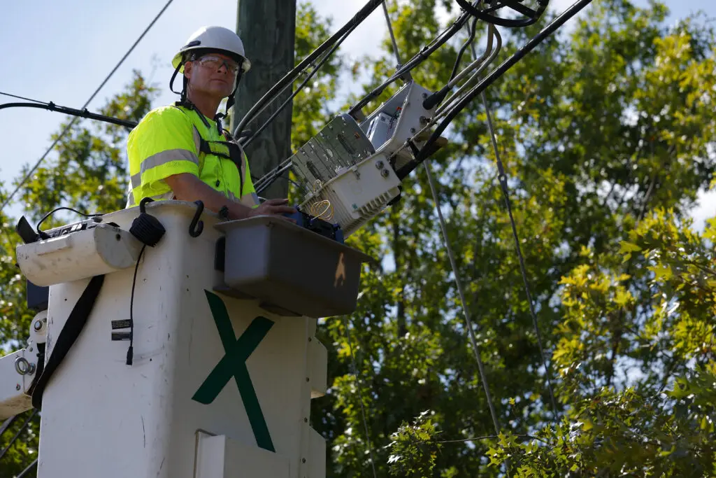 Comcast technician repairing damaged lines cause by Hurricane Helene