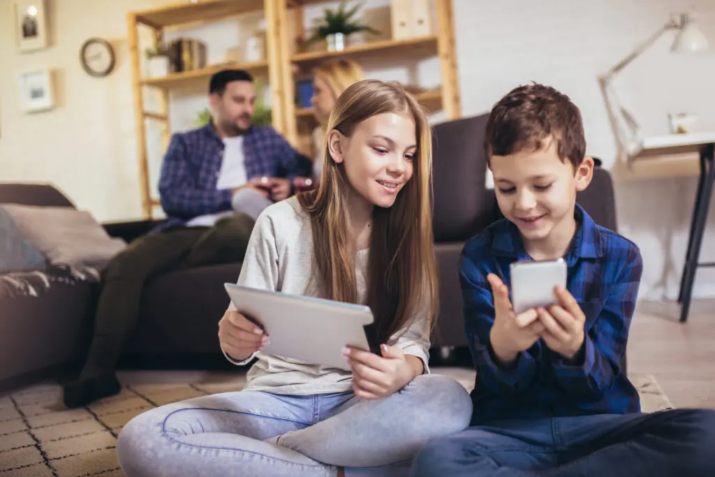 A family, including two children, are on devices with superfast internet connectivity through Xfinity Mobile hotspots.