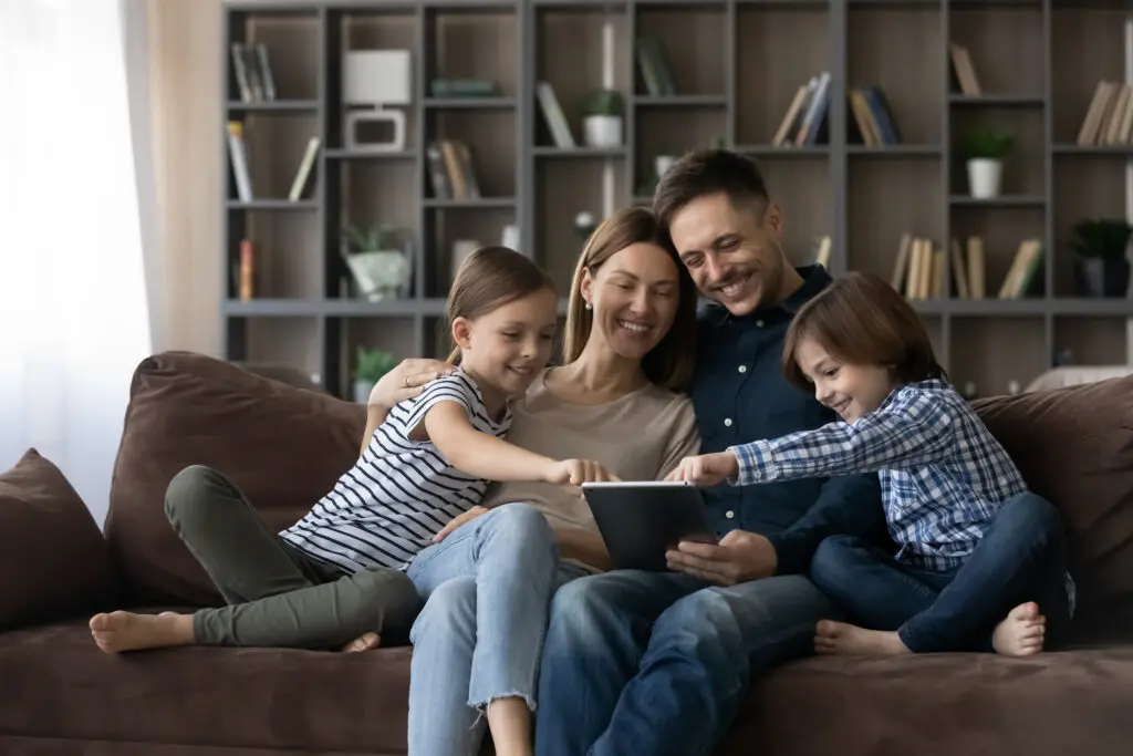 A family on devices connected to Xfinity Internet in a southern state. They are a part of the company’s Five-Year Price Guarantee offering no contract, unlimited data and one year of Unlimited Xfinity Mobile included.