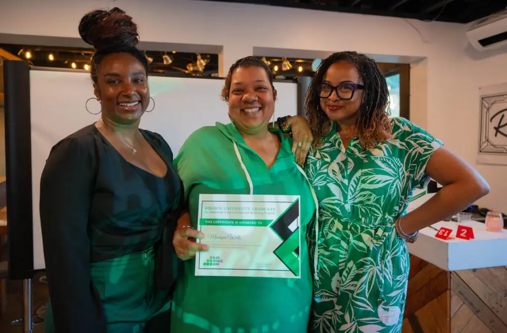 Danielle McGee, founder and CEO of Black Business Boom in Nashville, Tennessee and former Comcast RISE recipient. She is standing next to two entrepreneurs that she works with in her business.