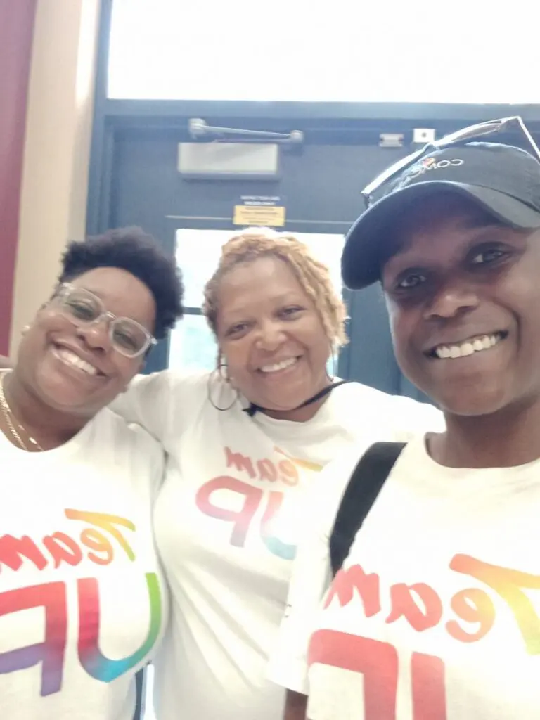 Three volunteers in Team UP t-shirts