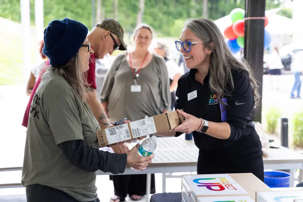 Liberty Place resident and veteran receives a laptop at the Comcast Lift Zone opening