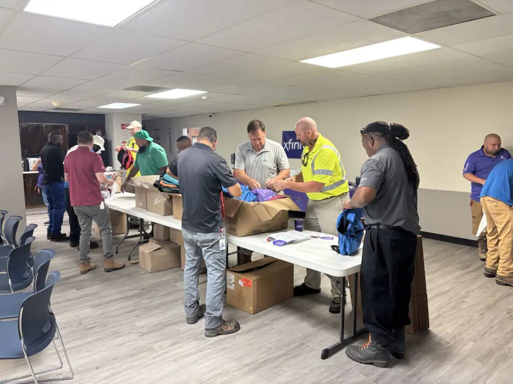 Comcast packs backpacks for the African American Parade Committee’s back-to-school drive, joined by Former State Representative Barbara Norton.