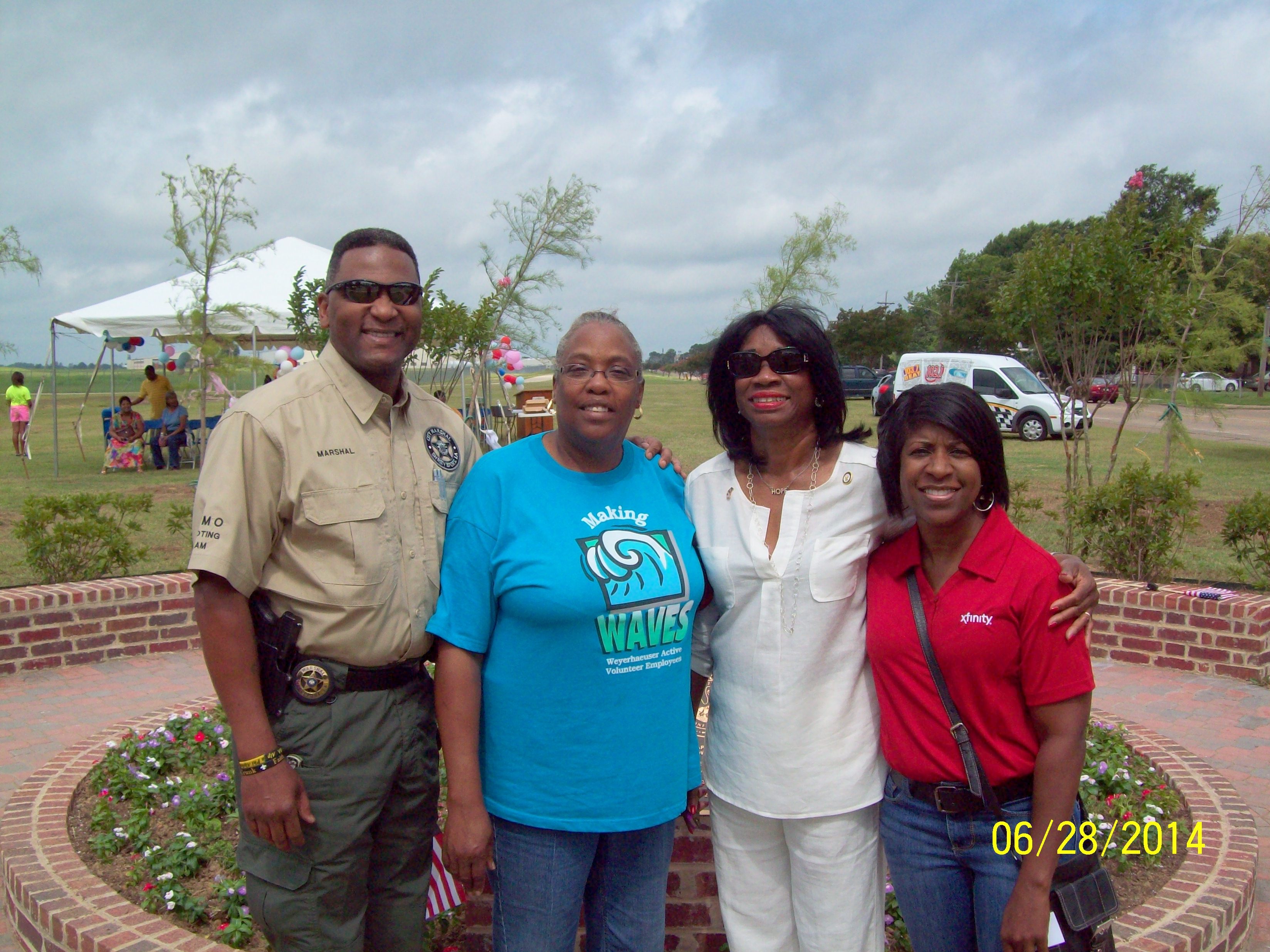 Rep. Barbara Norton (right center) joins Comcast employee (far right) Florence Jackson and Shreveport officials.