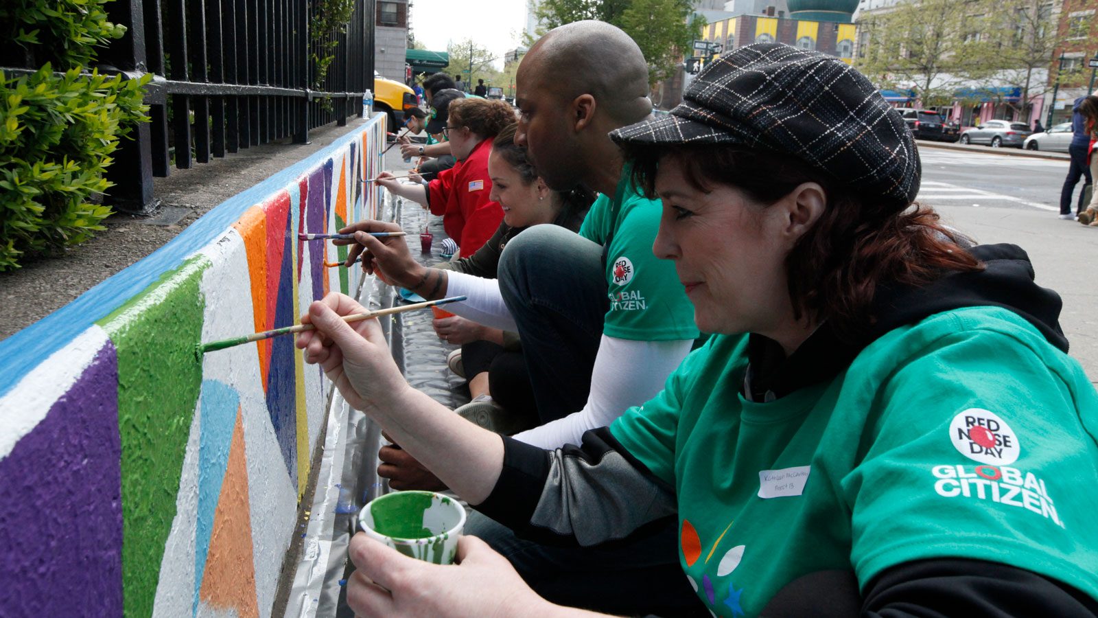 Comcast Cares Day volunteers painting mural