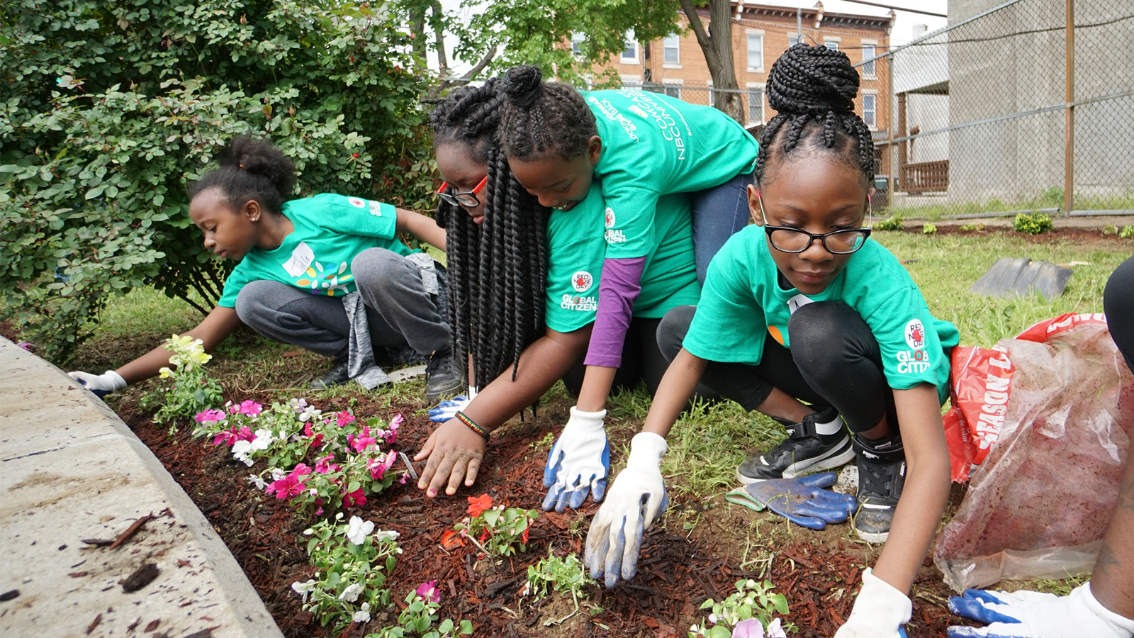 Comcast Cares Day volunteers work on a garden