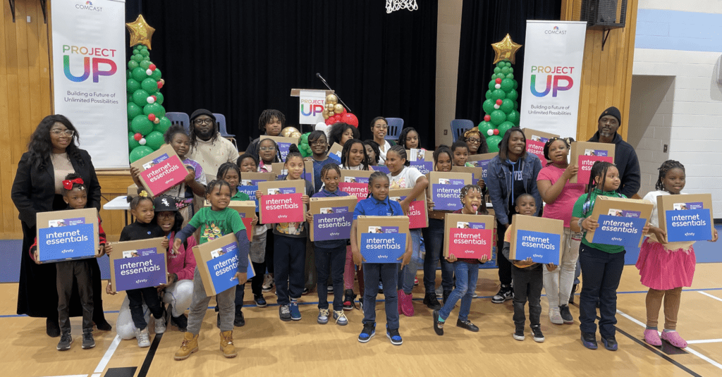 Families of the students at KIPP Ways celebrate the Comcast laptop donation to advance digital equity.