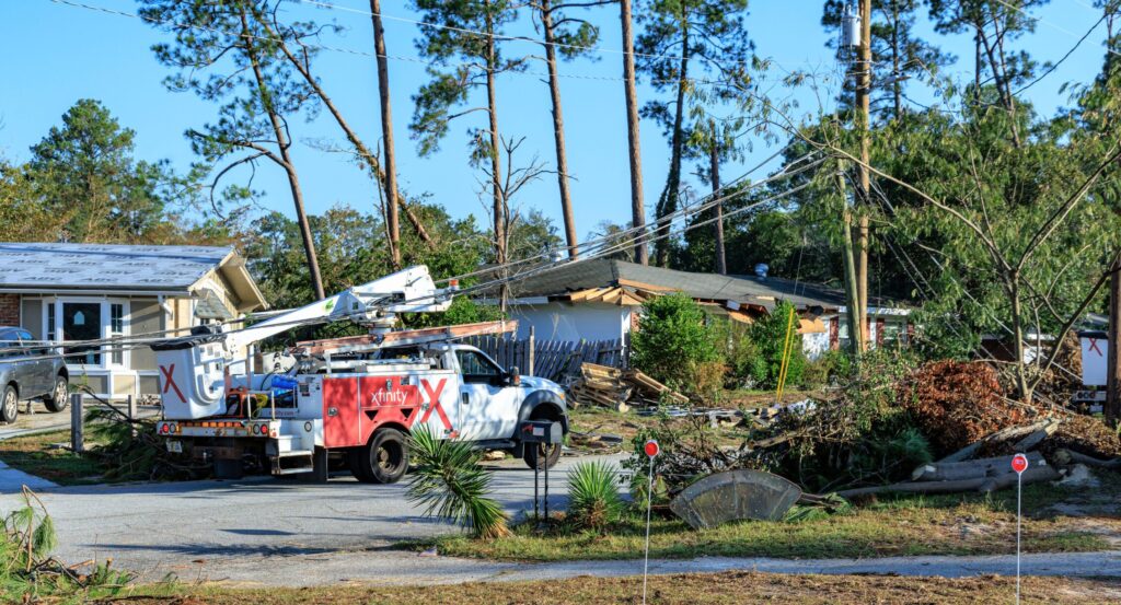 Comcast techs with a bucket truck work to repair downed lines post severe weather to restore connectivity for customers.