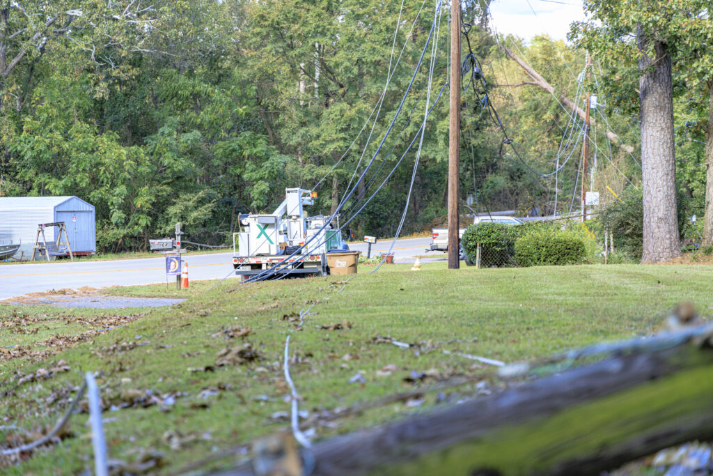 Xfinity tech working through downed lines and poles after storm to restore connectivity.