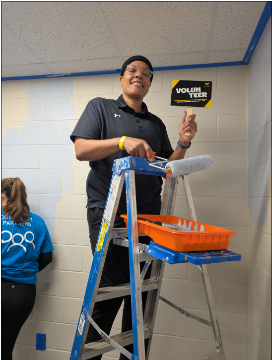 Shante Robinson is packing sanitary kits, while Dalana Watson and Lavon Dillon are painting spaces throughout Hollis Innovation Academy.