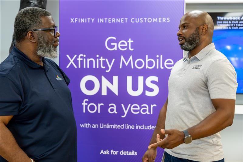 Xfinity retail employee and customer at the official store opening
